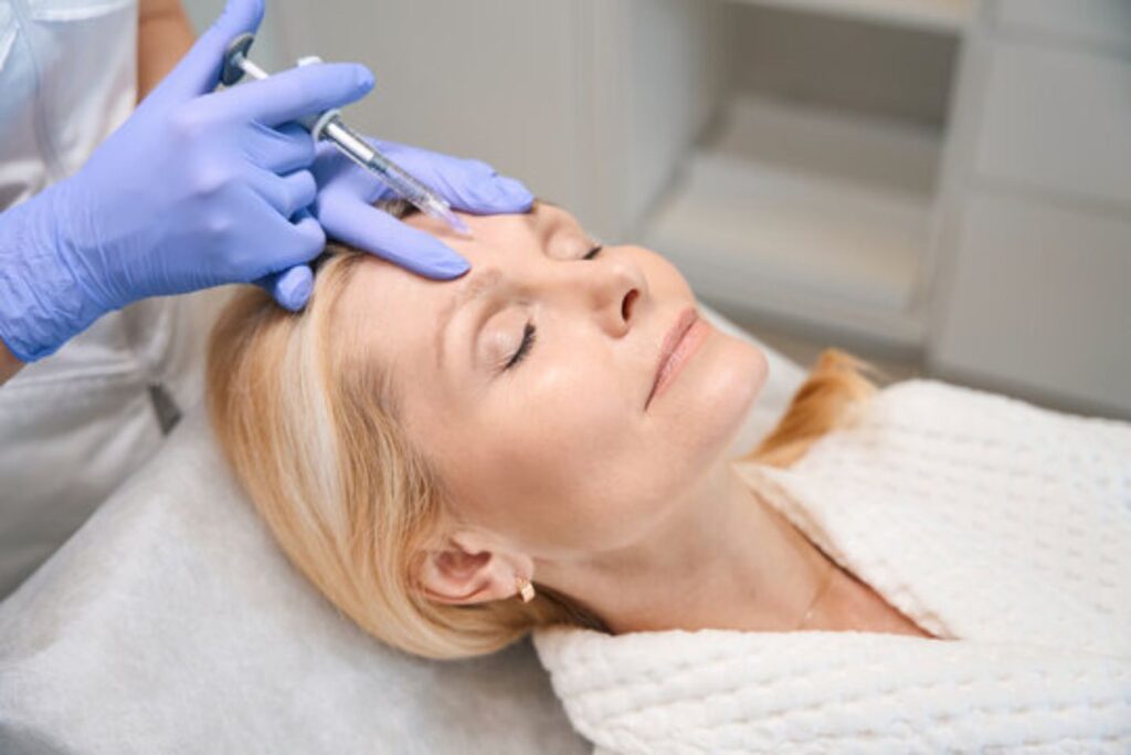 woman receiving botox injection on forehead at medical spa