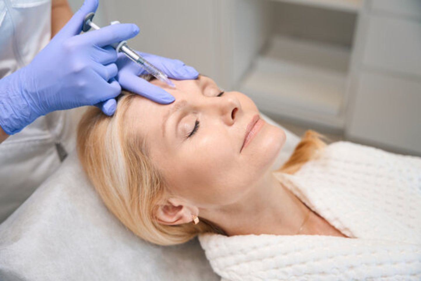 woman receiving botox injection on forehead at medical spa