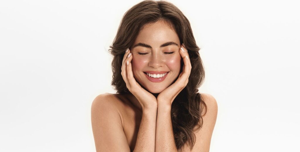 happy young woman with smooth glowing skin showing long-lasting filler results